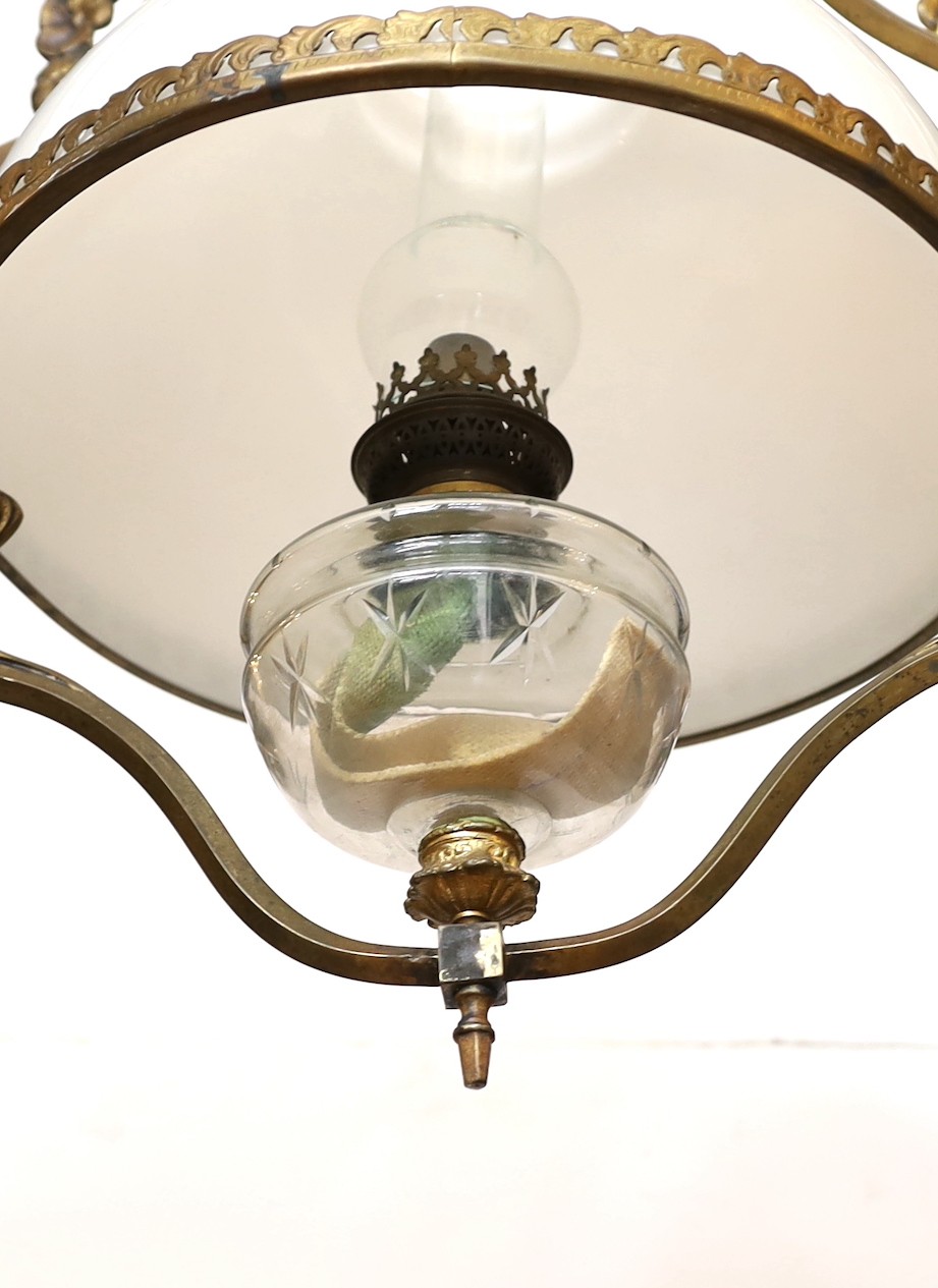 A late 19th century French bronze and cut glass hanging oil lamp with opaque glass shade, drop 90cm.